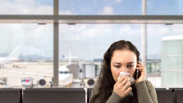 Stock photo of a woman wiping nose