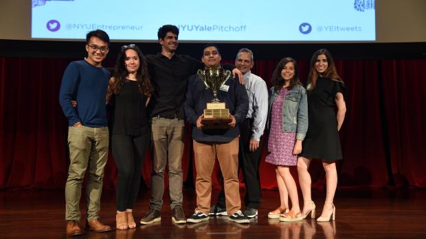 Winners of the NYU-Yale Pitchoff Anthony Oganov (third from left) and Amar Seoparson (holding trophy) flanked by competing participants of the Summer Launchpad program.