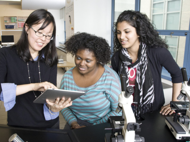 Prof Jin Montclare with two women students of color in lab