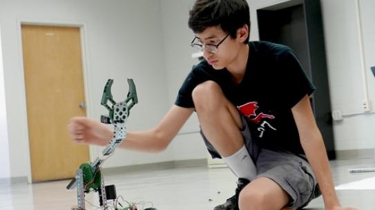 STEM student with robot