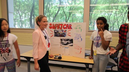 Science of Smart Cities students show off their own self-navigating smart car. 