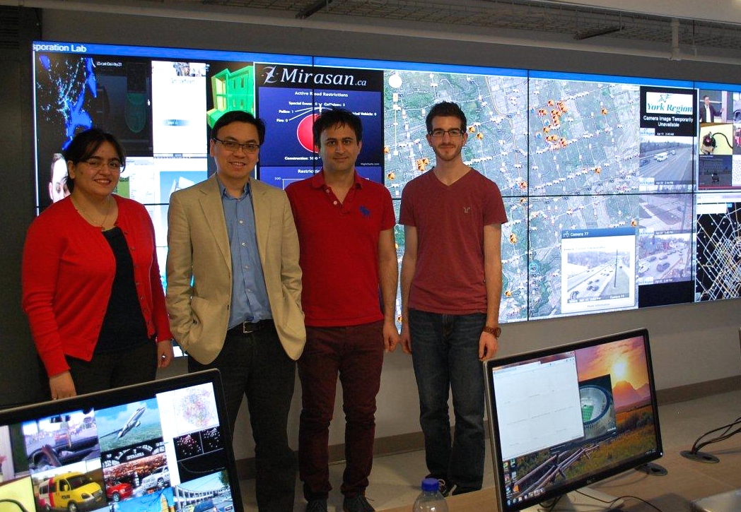 group standing in front of a screen displaying map data 