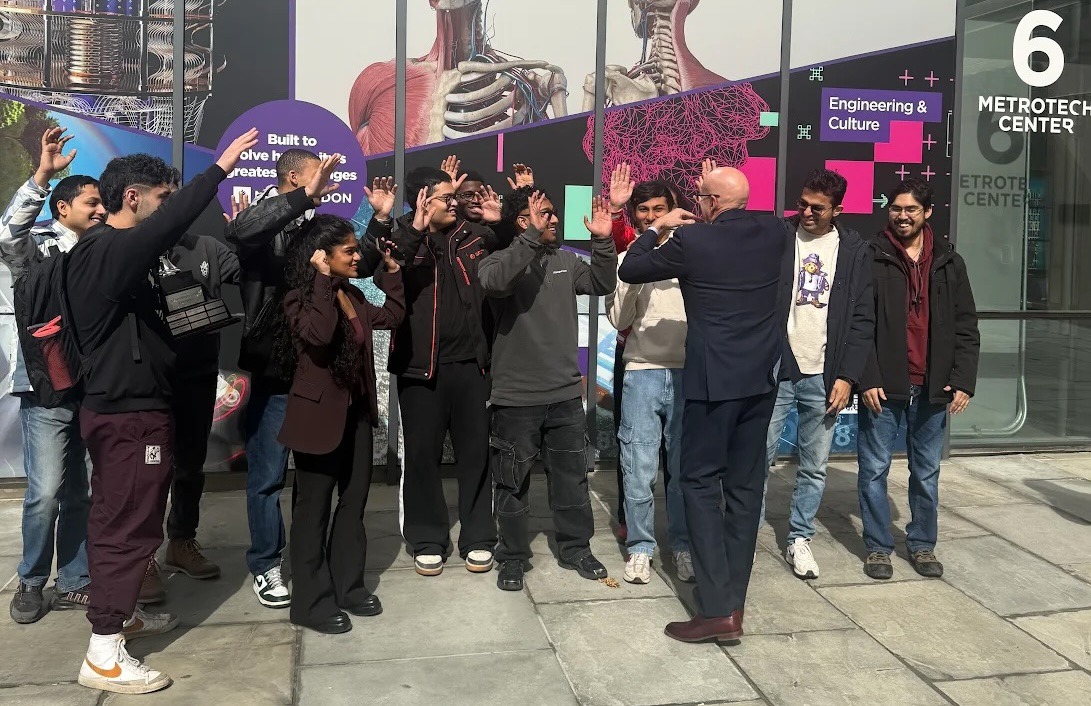 Students high-fiving Dean Juan de Pablo