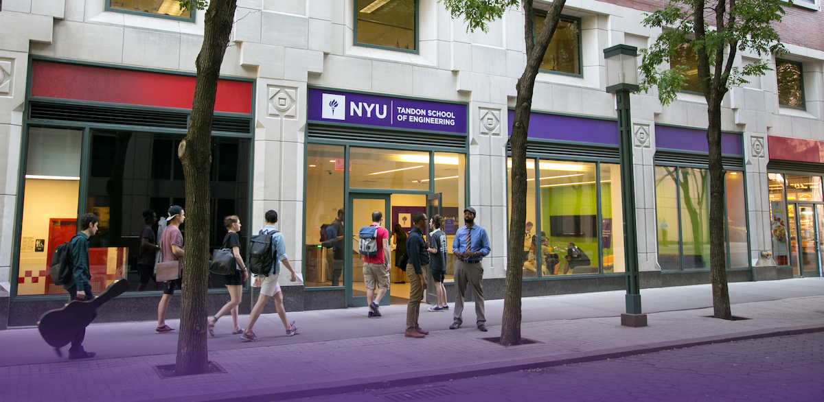 Students walking along cambus building branded with NYU Tandon sign