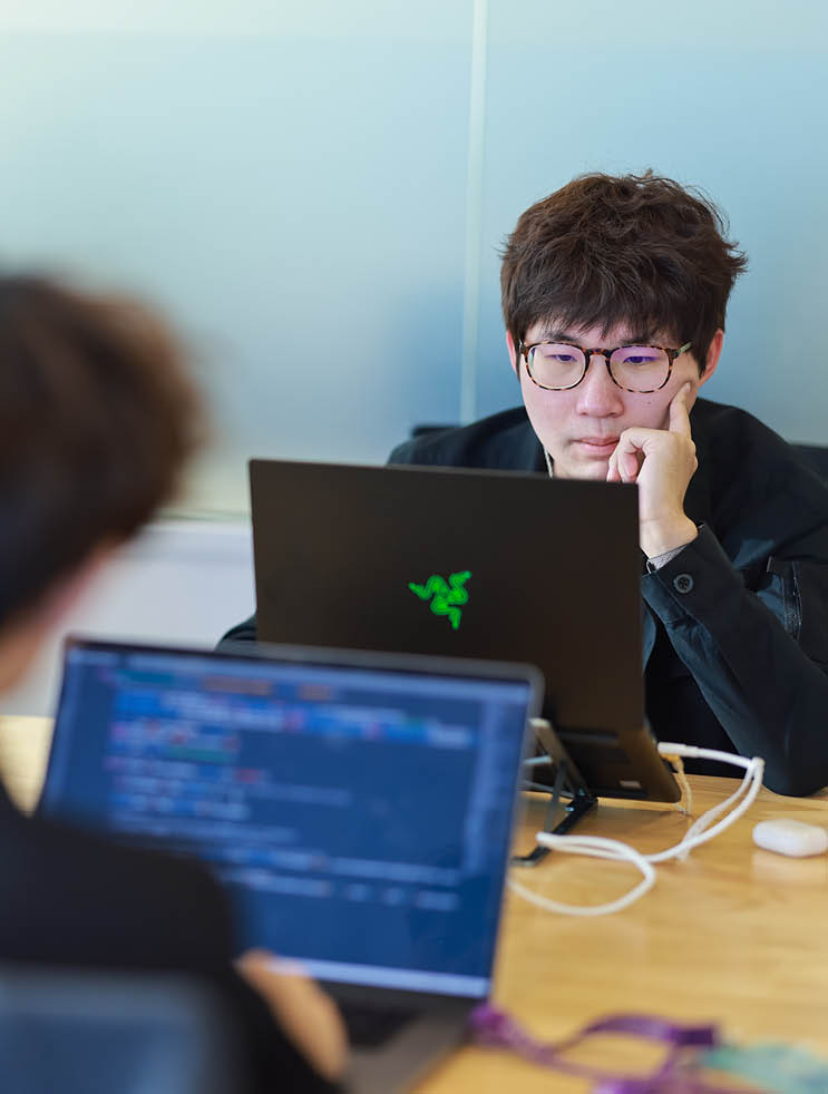 Students on their laptops coding