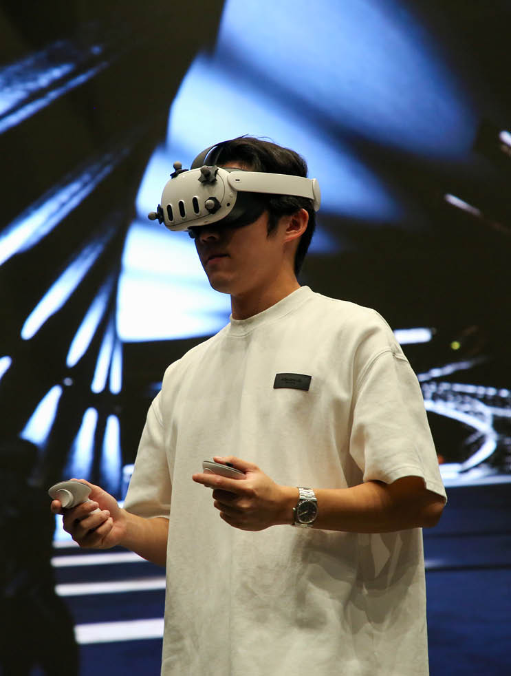 student wearing a VR headset and using hand controllers