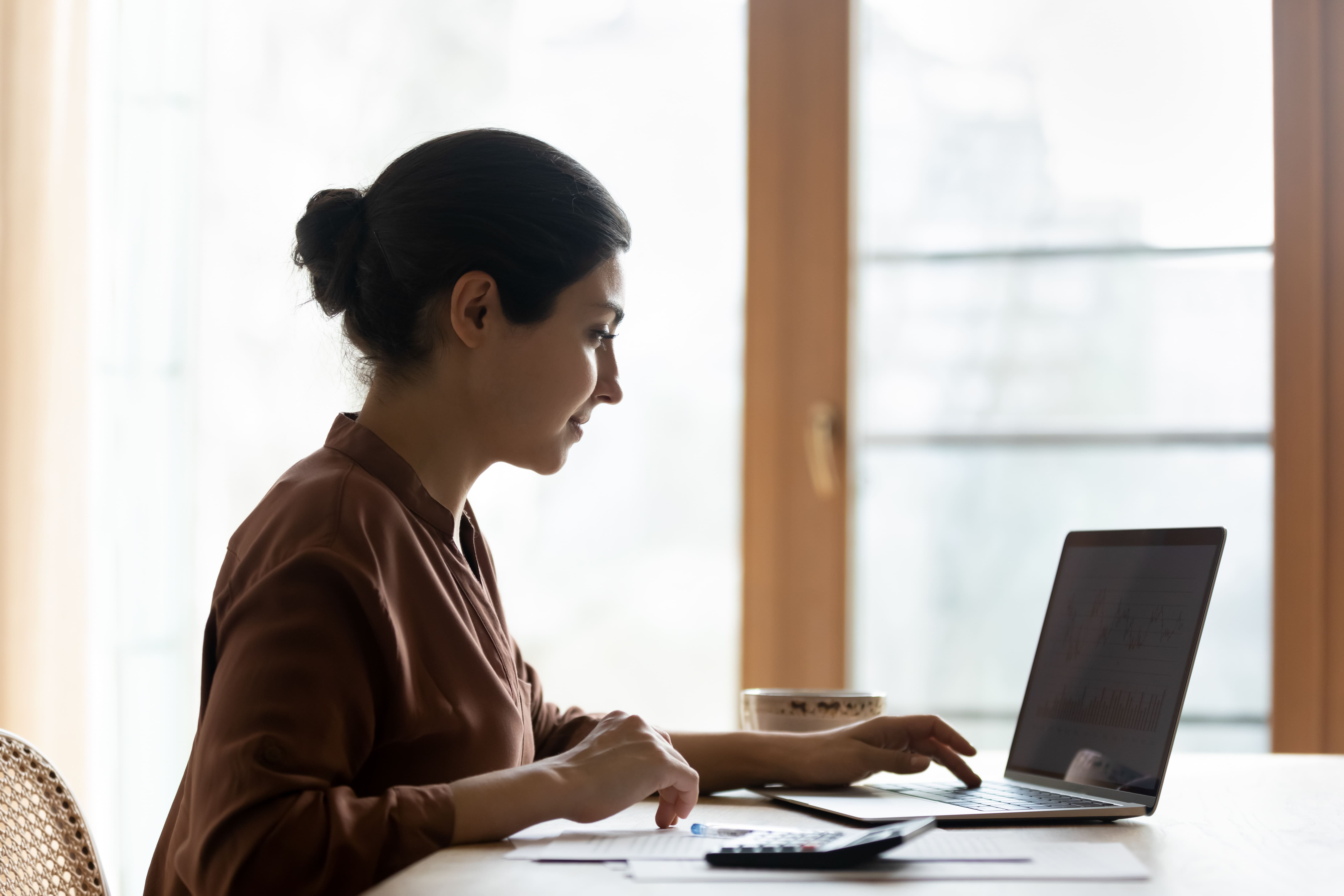 A woman is using her laptop.