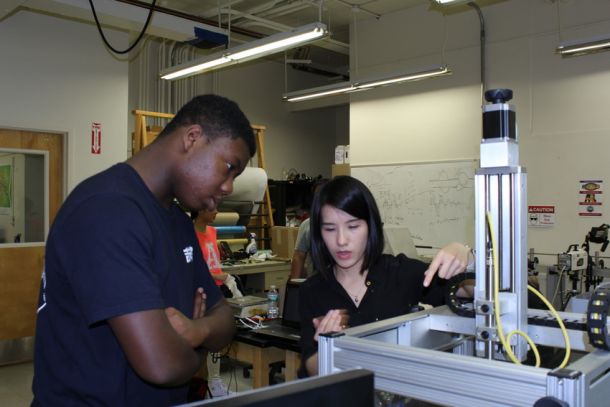 High school student Bolutiwi Kilanko, a participant in NYU Tandon's STEMNow ARISE (Applied Research Innovations in Science and Engineering) workshop learns about 3D printing from doctoral student Fei Chen.