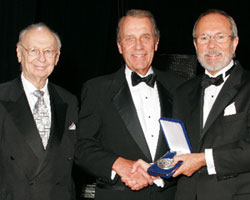 President Jerry MacArthur Hultin , right, is joined by Clifford H. Goldsmith, left, Promise Fund founder, former vice chairman of the University's Board of Trustees and principal of The Prendel Company in presenting Henry J. Singer '57 '64 with the President's Medal for Distinguished Service. Singer has served chairman of the Promise Fund Board for 16 years, and on Poly's the Board of Trustees since 1986, most recently as vice chairman. He is president of Reg-Nis LLC, a business consulting firm. 