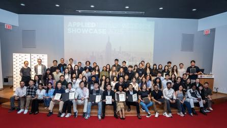 Urban Data Science Class of 2025 sitting on the stage of Pfizer Auditorium