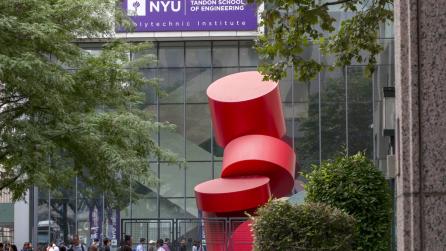 red sculpture outside on a campus building with purple NYU Tandon signage