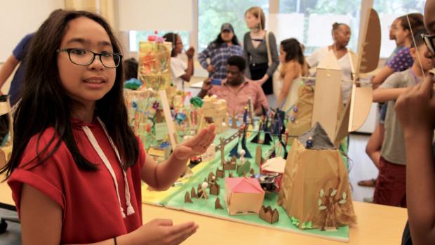 A Science of Smart Cities participant shows off the features of a city she and her teammates created.
