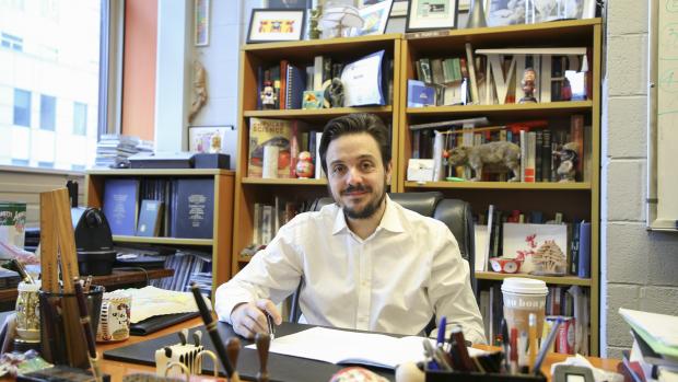 Maurizio Porfiri in his office with bookshelves in background