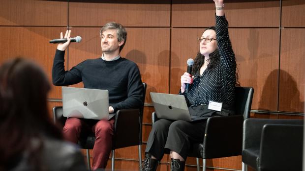 NYU Tandon professors sitting on panel raising their hands