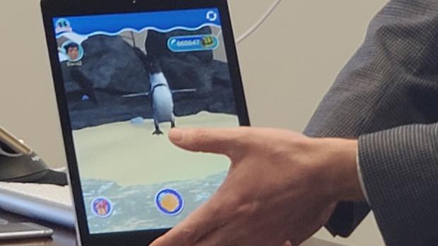 ipad with a penguin on screen