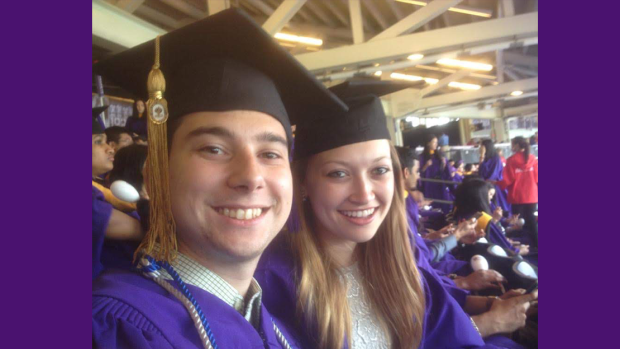 smiling couple in graduation cap and gown