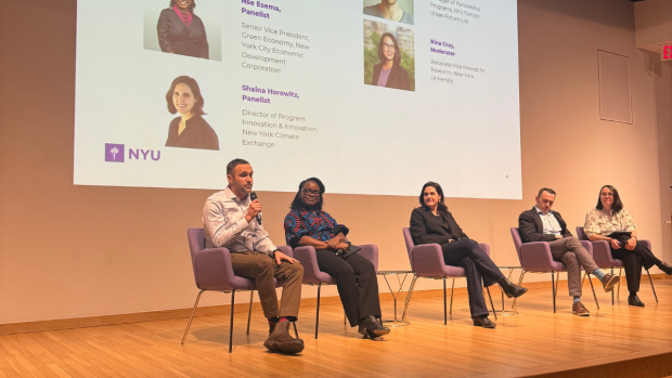 a panel of speakers on stage