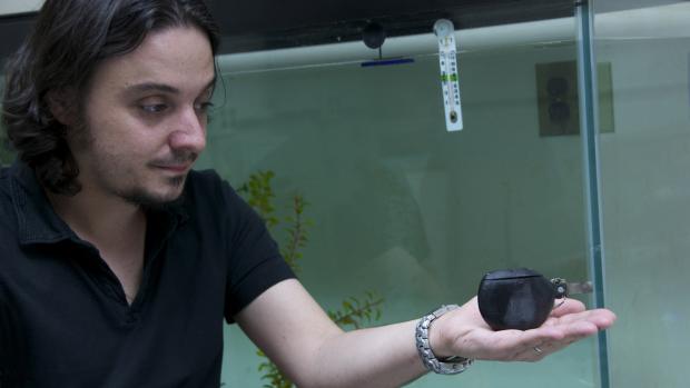 Maurizio Porfiri holding a robot fish