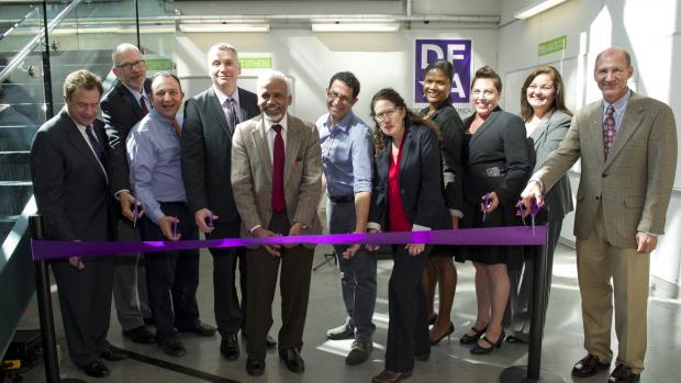 Dean Sreeni with other people cutting ribbon