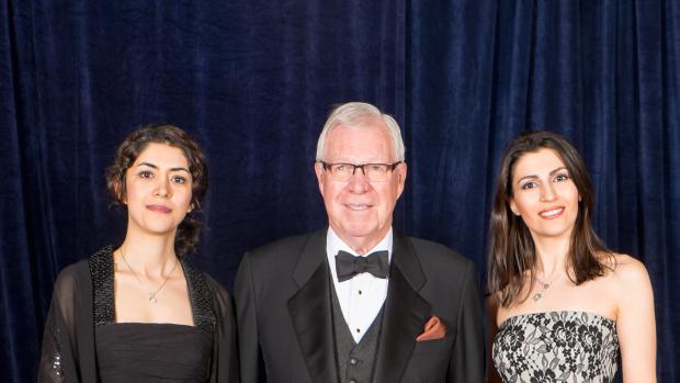 Prof. Bud Griffis in tuxedo flanked by two women