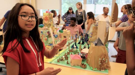 A Science of Smart Cities participant shows off the features of a city she and her teammates created.