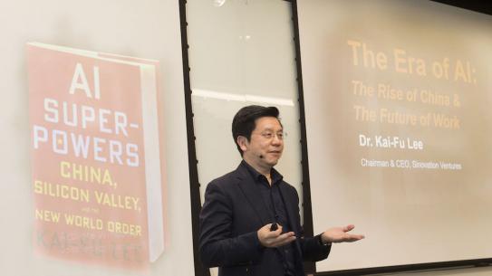 Kai-Fu Lee with image of his book projected behind him