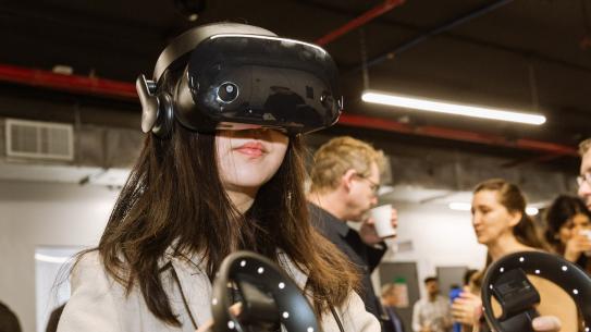 female student wearing a VR headset and holding controllers