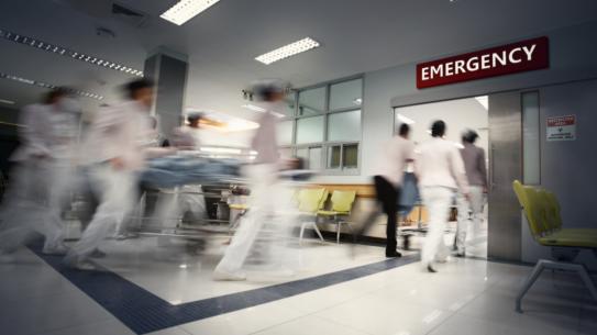 people rushing inside of a hospital emergency room
