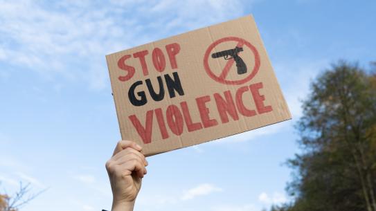 Stock image of a sign stating stop gun violence