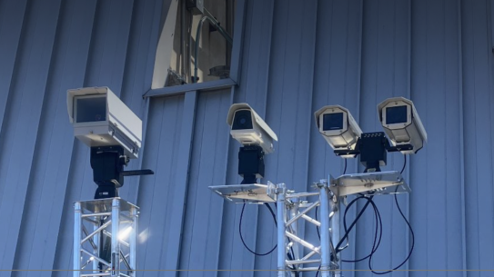Four cameras mounted to a steel platform.