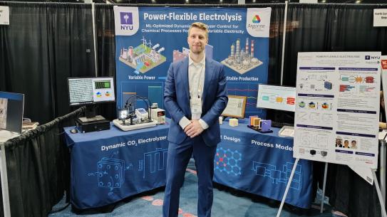 standing in front of poster display