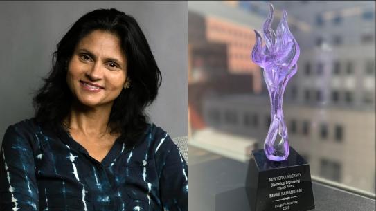 Nimmi Ramanujam next to a purple award
