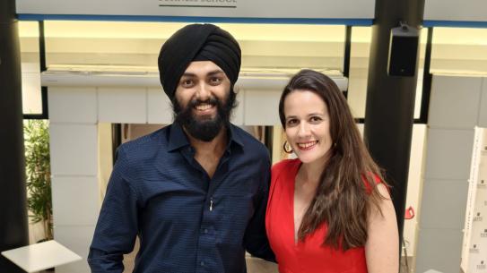 Two people, one man and one woman, standing next to each other.