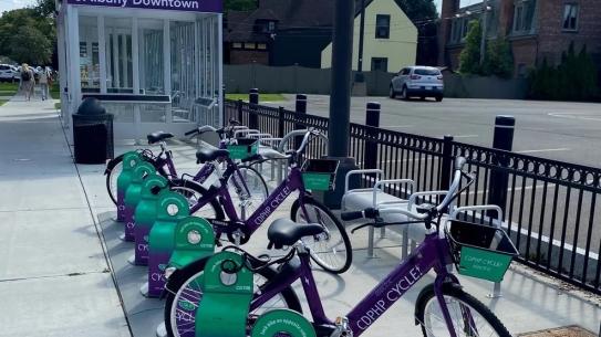 Four purple CDPHP docked at a station in a row