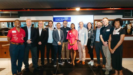 Innovate UK Cohort 4 standing and smiling for a photo