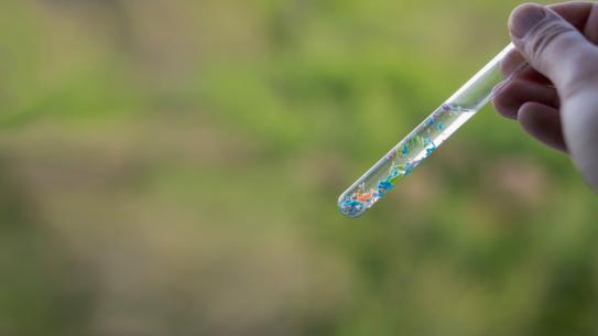Hand holding test tube background