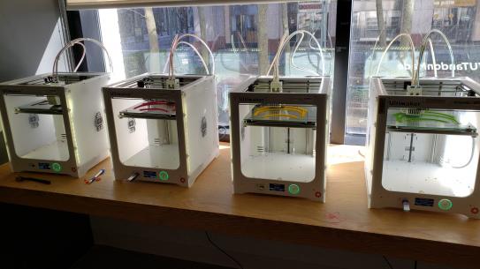 row of 3d printers in makerspace