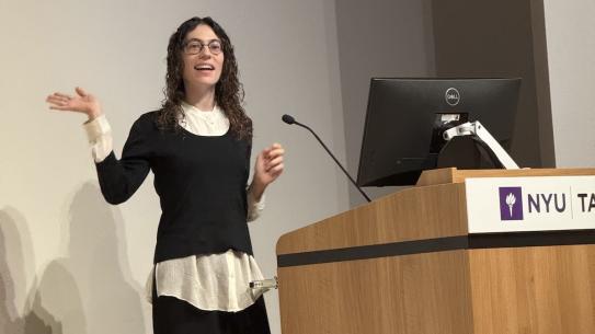 a woman speaking at lecturn