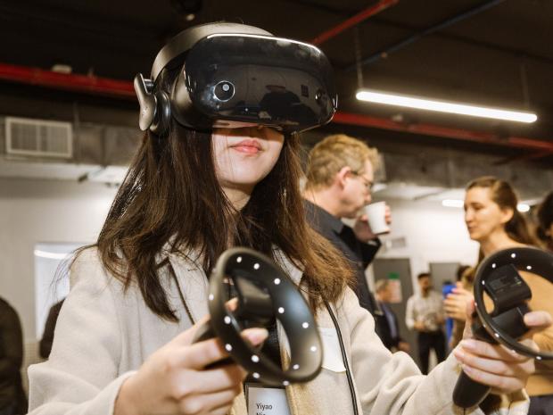 female student wearing a VR headset and holding controllers