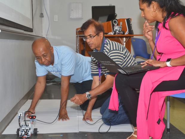 Teachers working on a robot's movement
