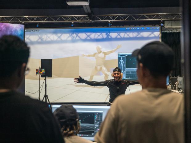person in front of motion capture wall