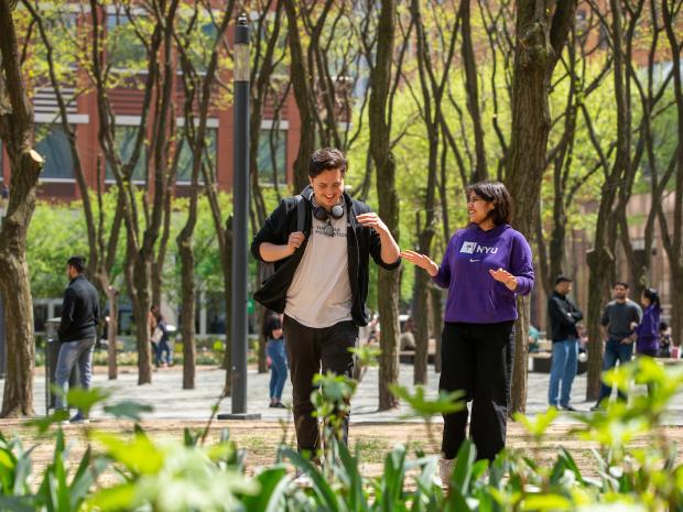 two smiling student walking through Brooklyn Commons