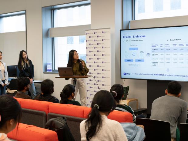 Three students presenting a slide that reads "Results - Evaluation" to a seated audience.