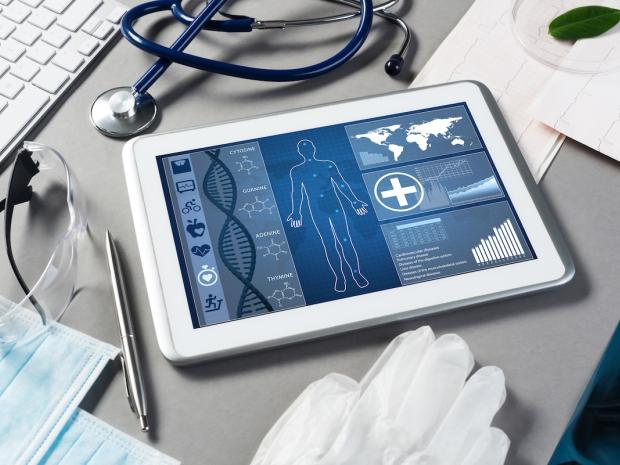 ipad with health info displayed next to a stethoscope 
