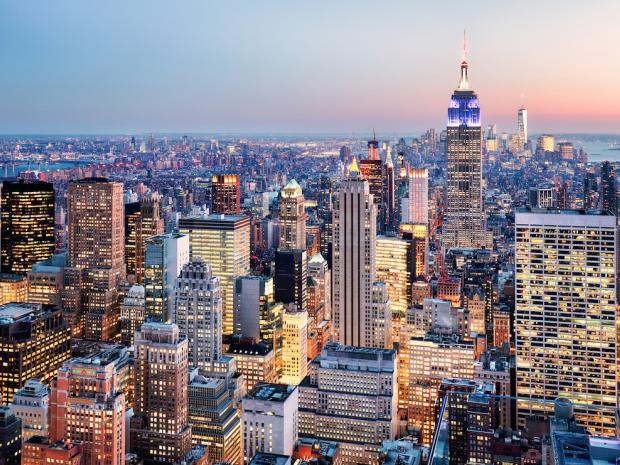NYC skyline lit up at twilight