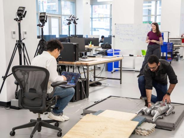 students working on a robot in a lab