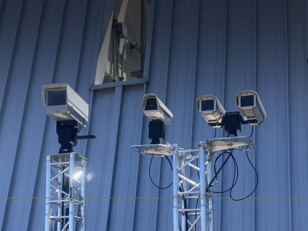 Four cameras mounted to a steel platform.