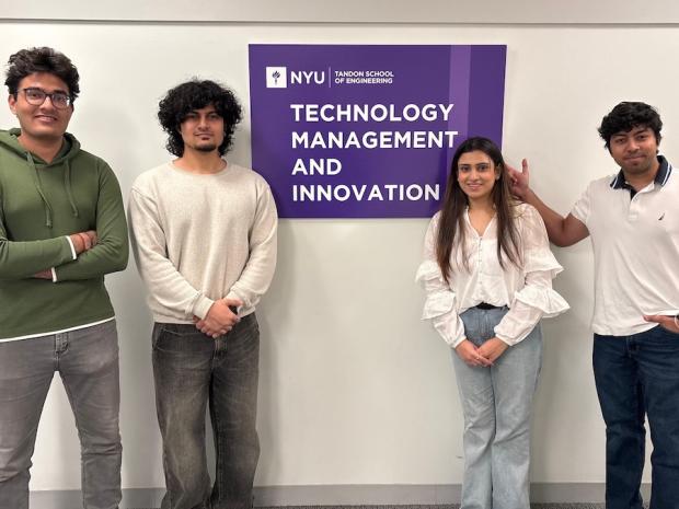 students posing in front of TMI Department sign
