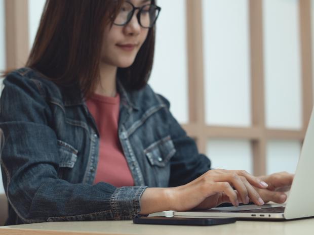 a student working at a laptop 