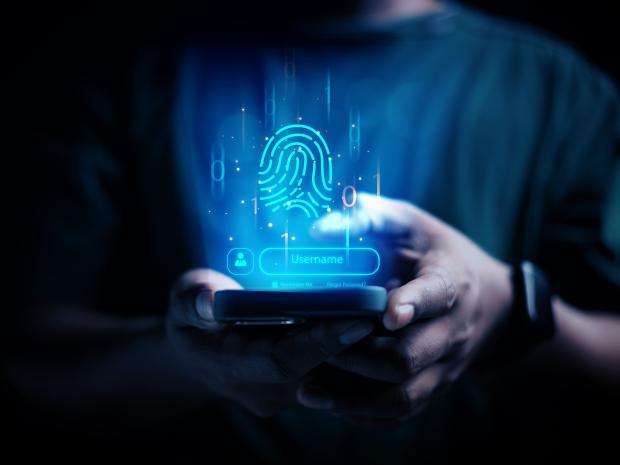 Person using phone, screen has username and fingerprint